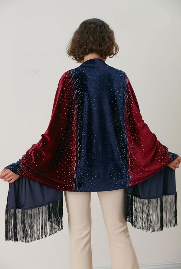 Woman wearing a red and blue patterned shawl with fringe details on a white background
