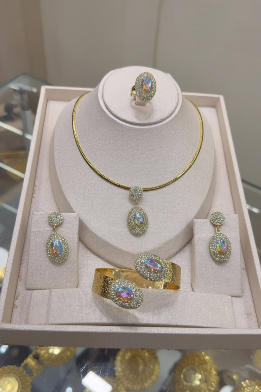 Jewelry set including necklace, earrings, and bracelet on a display stand with a blurred background.